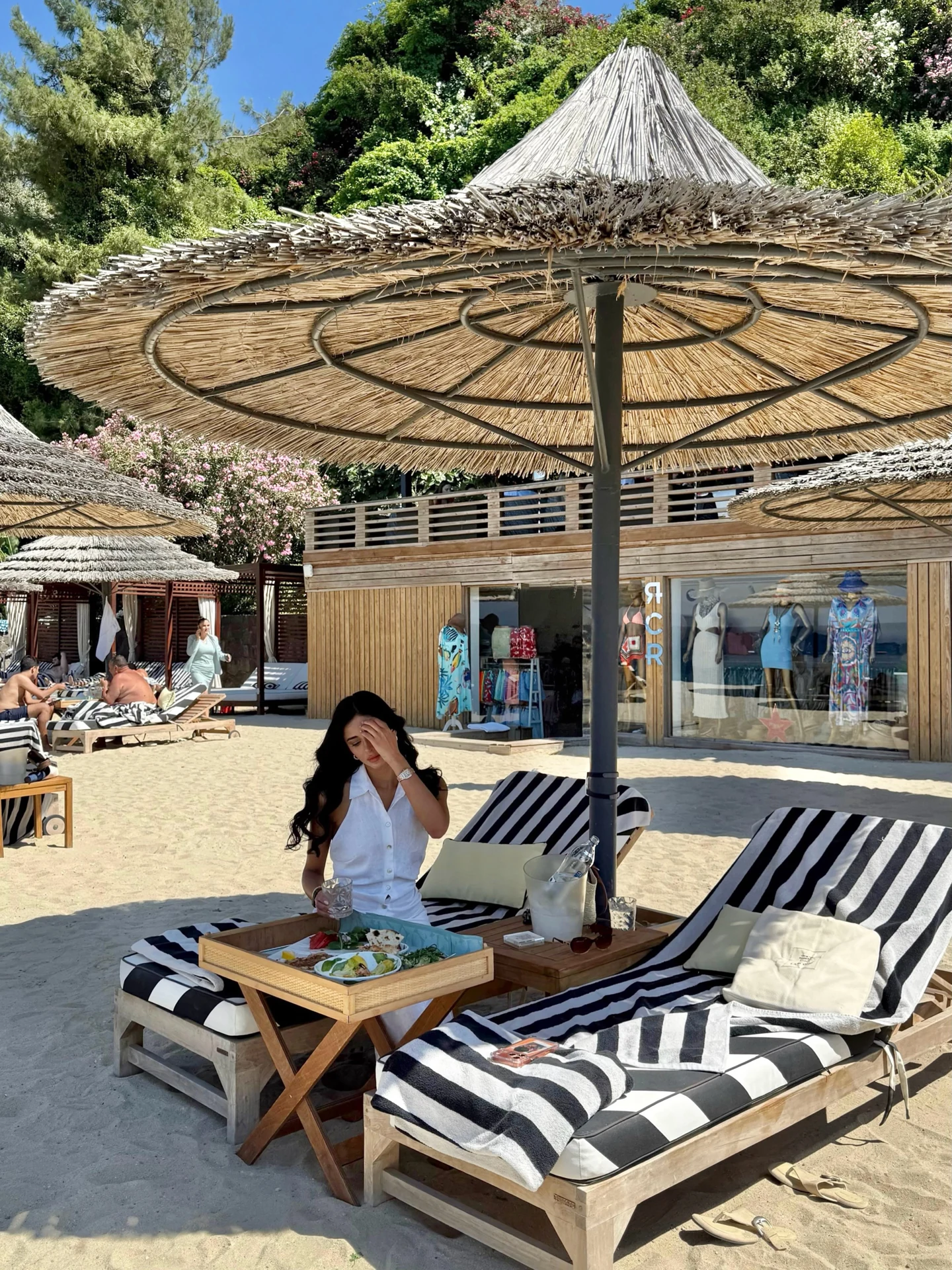 Rahaf seated beneath a parasol during her Bodrum stay