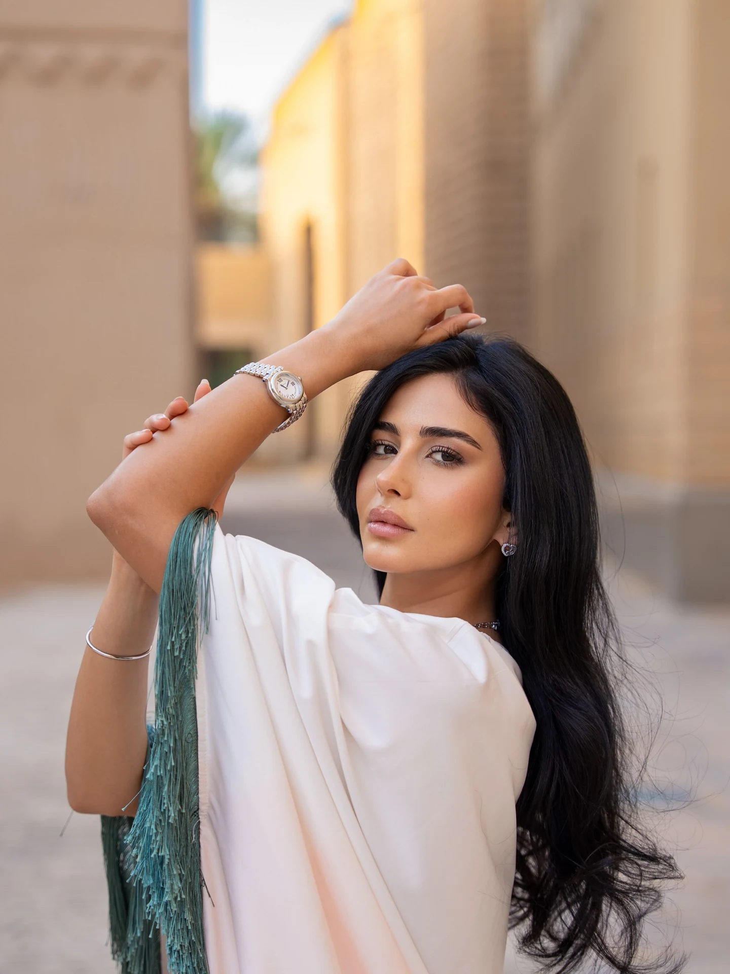 Rahaf Alharbi wearing a Chopard Happy Sport watch with a white and green outfit