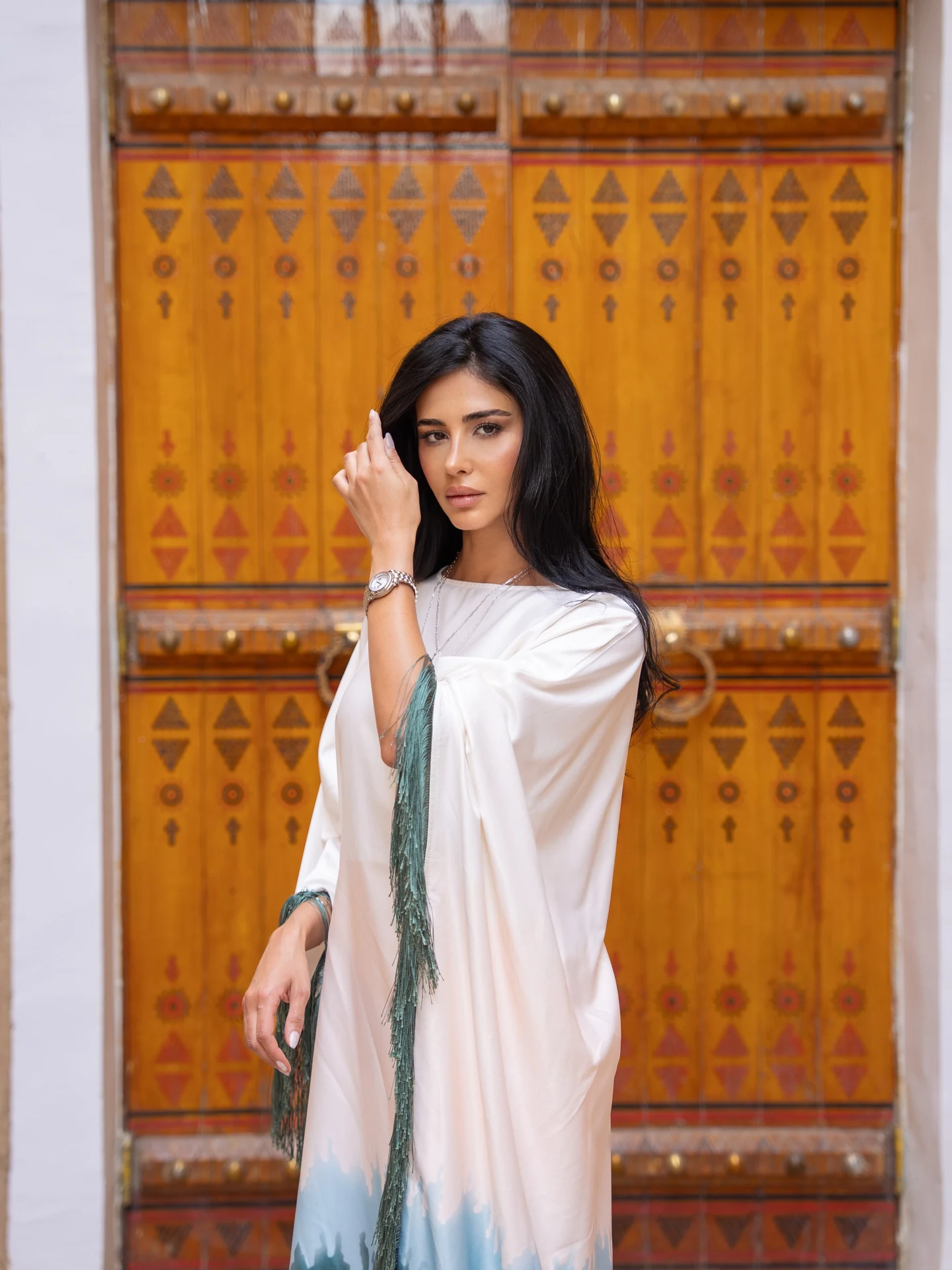 Rahaf Alharbi wearing Chopard beside a carved wooden door