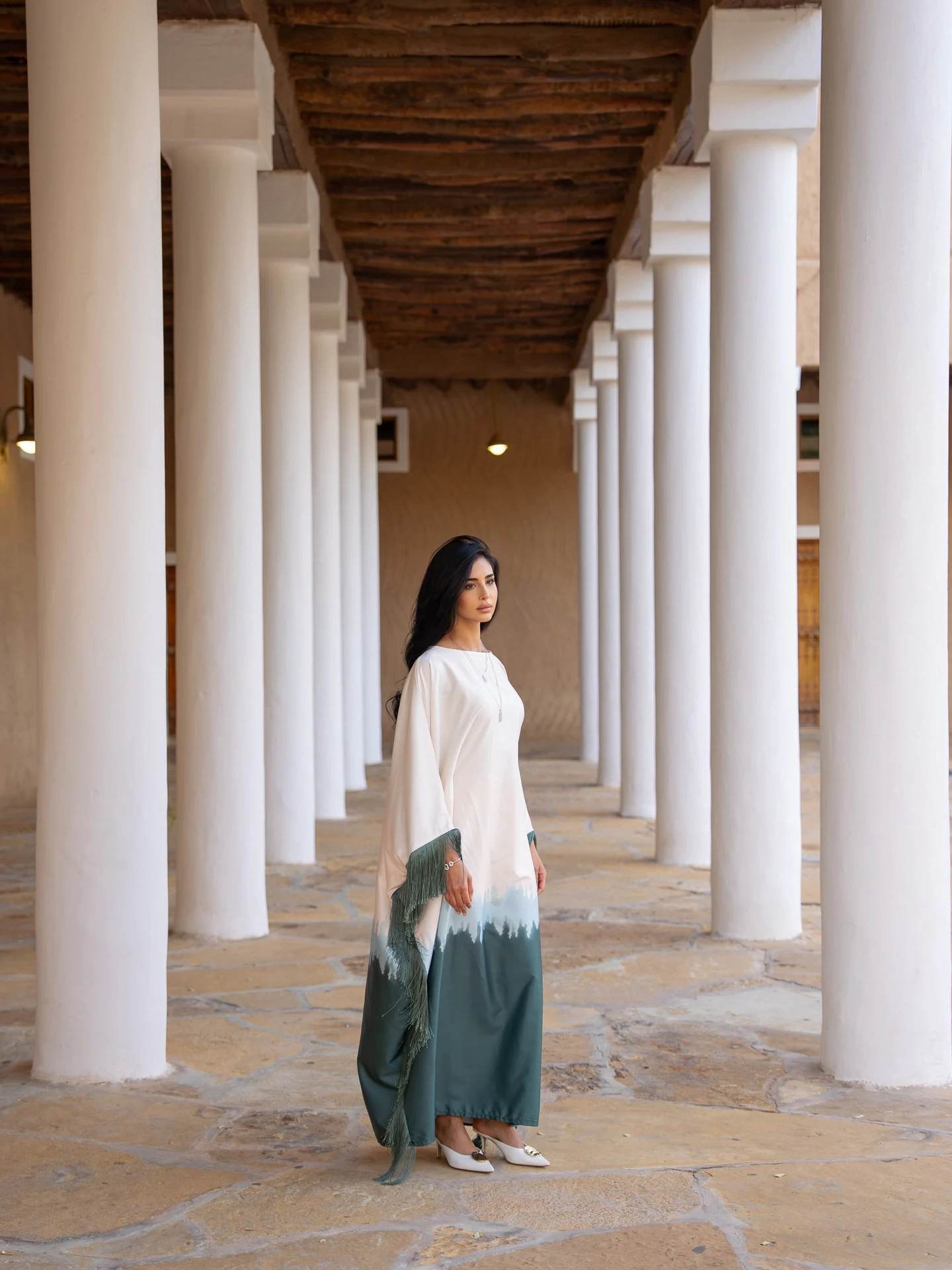 Full-length portrait of Rahaf Alharbi in a colonnade for Chopard