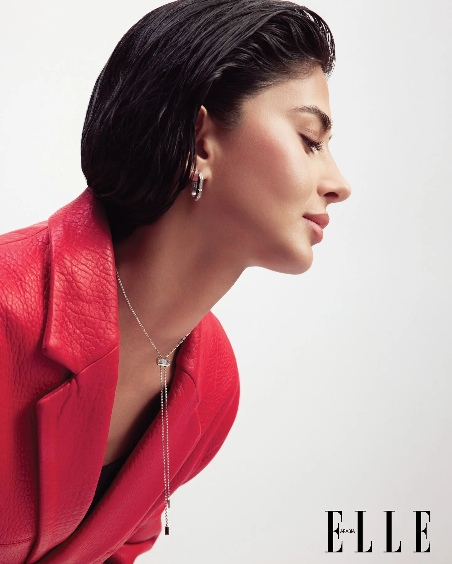 Rahaf in a red jacket wearing Messika jewelry for ELLE Arabia