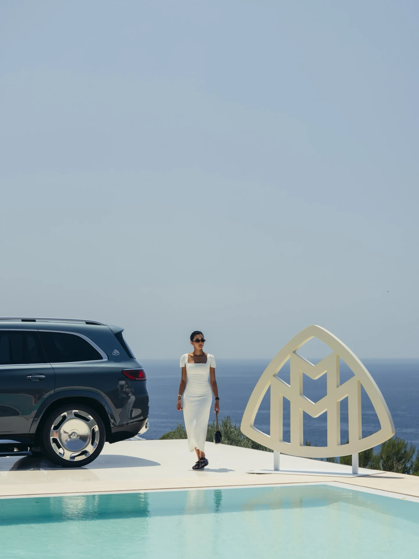 Rahaf beside a Mercedes-Maybach display overlooking the water