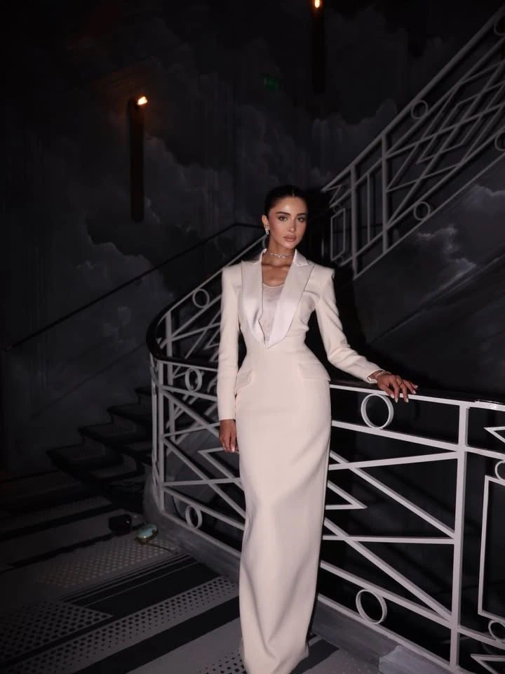 Full-length portrait of Rahaf Alharbi beside the staircase at the Messika show