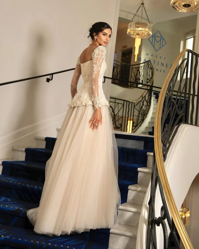 Rahaf on a staircase in her Cannes gown
