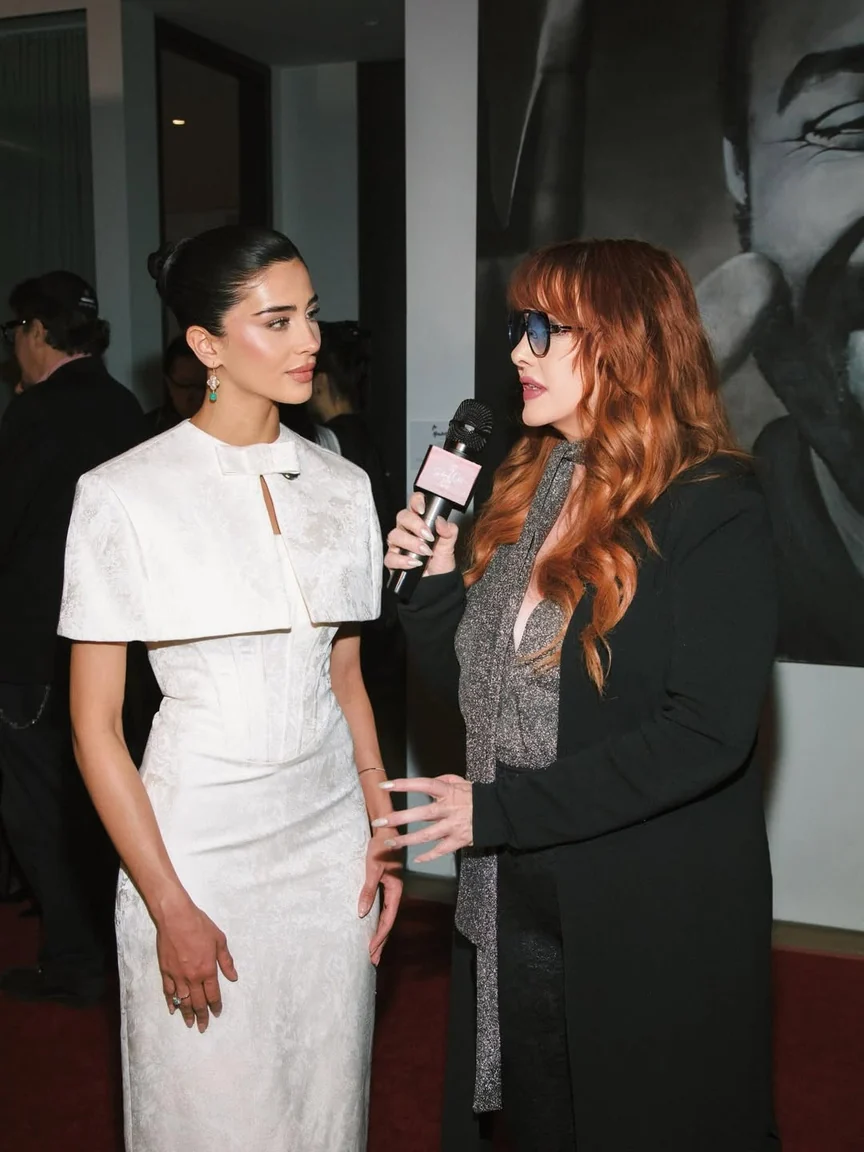 Rahaf speaking to an interviewer at the gala