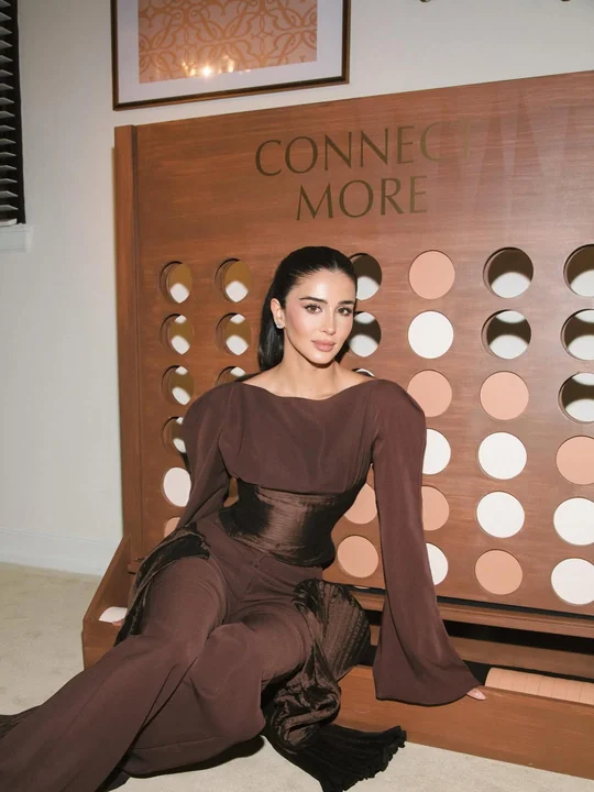 Rahaf seated at the Estée Lauder event