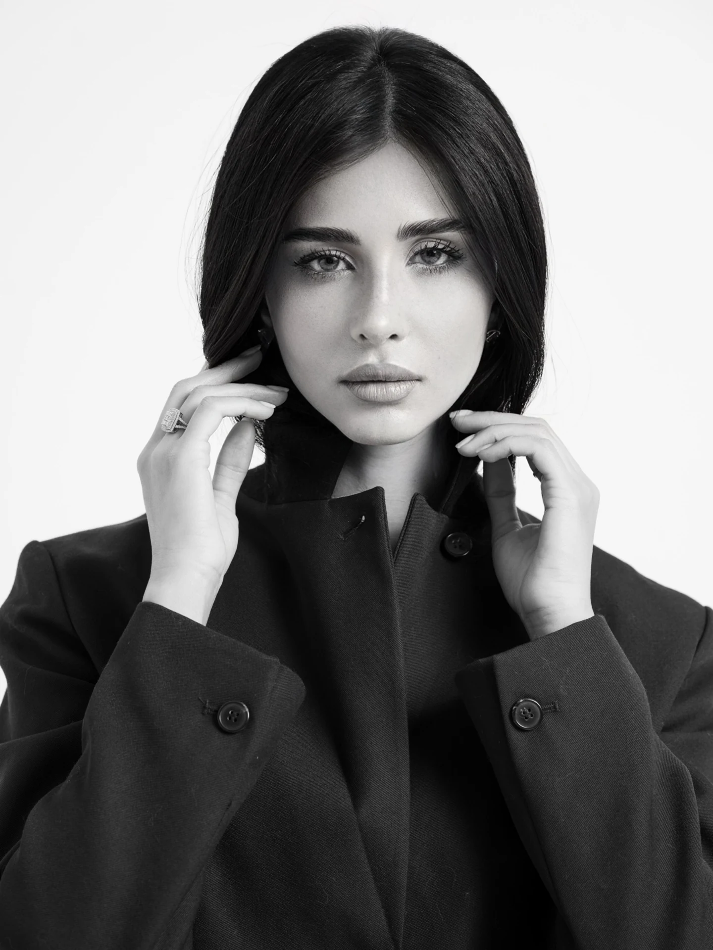 Black-and-white portrait of Rahaf in a dark blazer