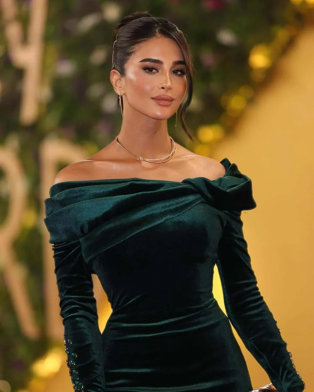 Rahaf Alharbi at the Joy Awards, close portrait with a blurred gold background
