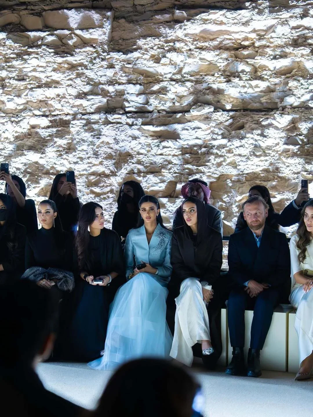 Pale-blue gown seated at fashion event